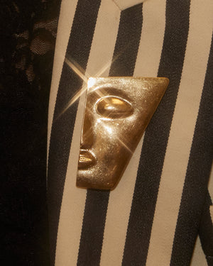Broche demi visage doré
